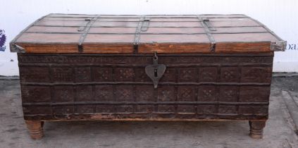 An Middle Eastern hardwood and iron bound low chest, with hinged lid and bun feet, H 56cm, W 129cm,