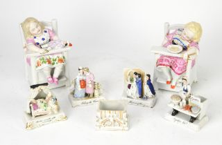 Pair of German figure groups of seated children in high chairs, 19th Century, modelled as boxes,
