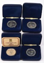 Four cased silver crown coins with C.O.A