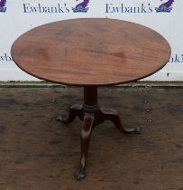 A George II mahogany tripod table, the two piece tilt-top on a gun barrel column with cabriole legs