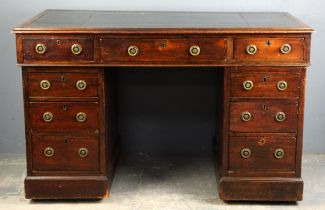 A Victorian mahogany kneehole pedestal desk, the leather inset top above nine drawers,