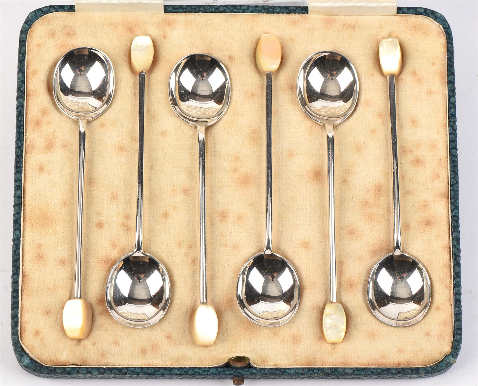 Cased set of silver spoons with mop finials.