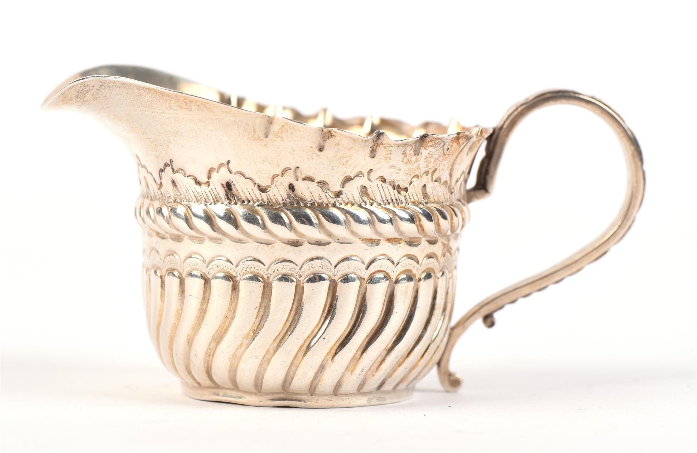Silver cream jug with demi fluted embossed design. Birmingham, 1890.