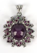 A star ruby and diamond brooch, with a central round cabochon cut star ruby measuring 12.76mm,