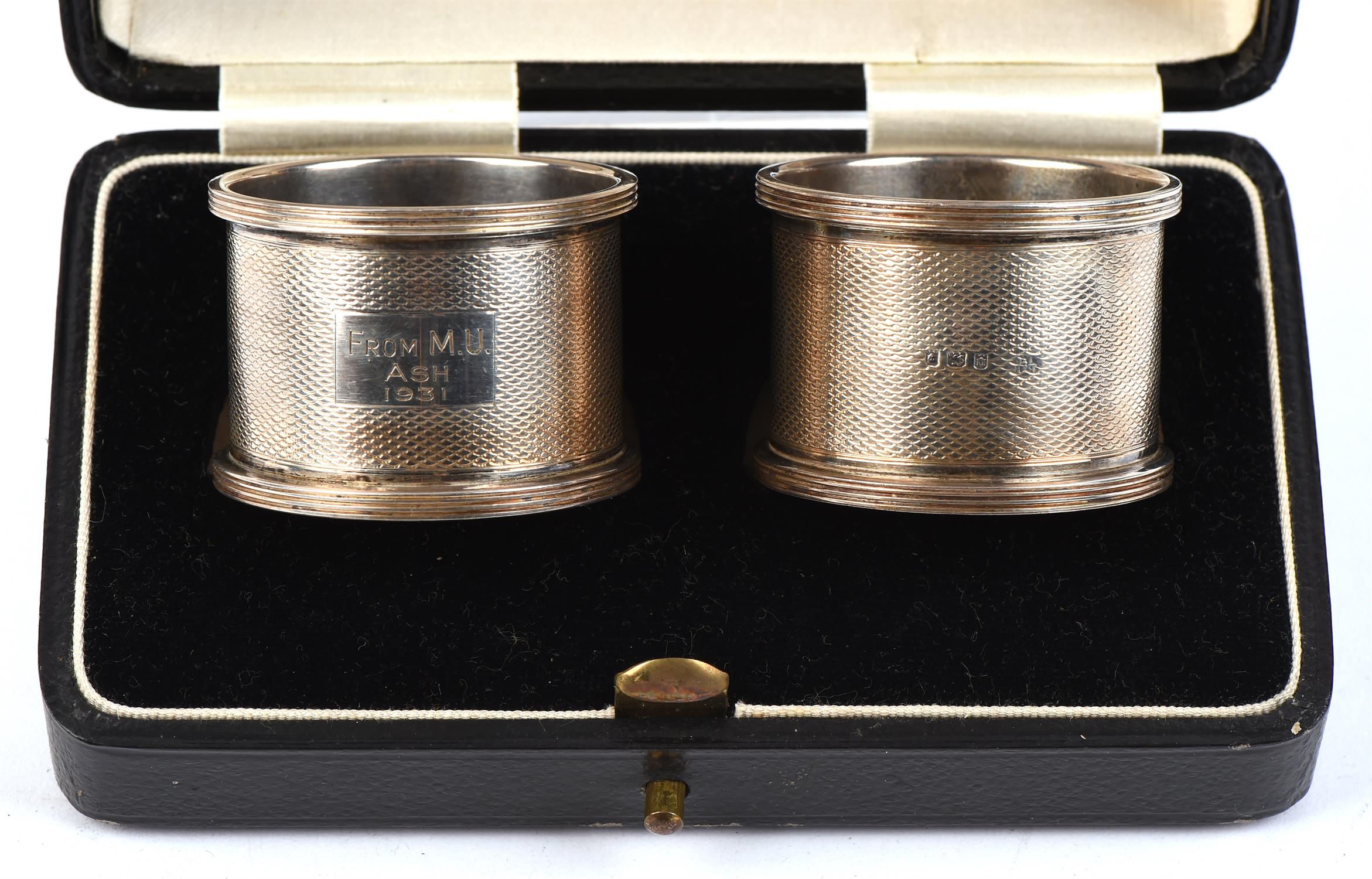 Cased pair of silver napkin rings, Engine turned finish