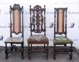 Two ebonised William and Mary chairs, with scroll carved crestings and caned panel backs,
