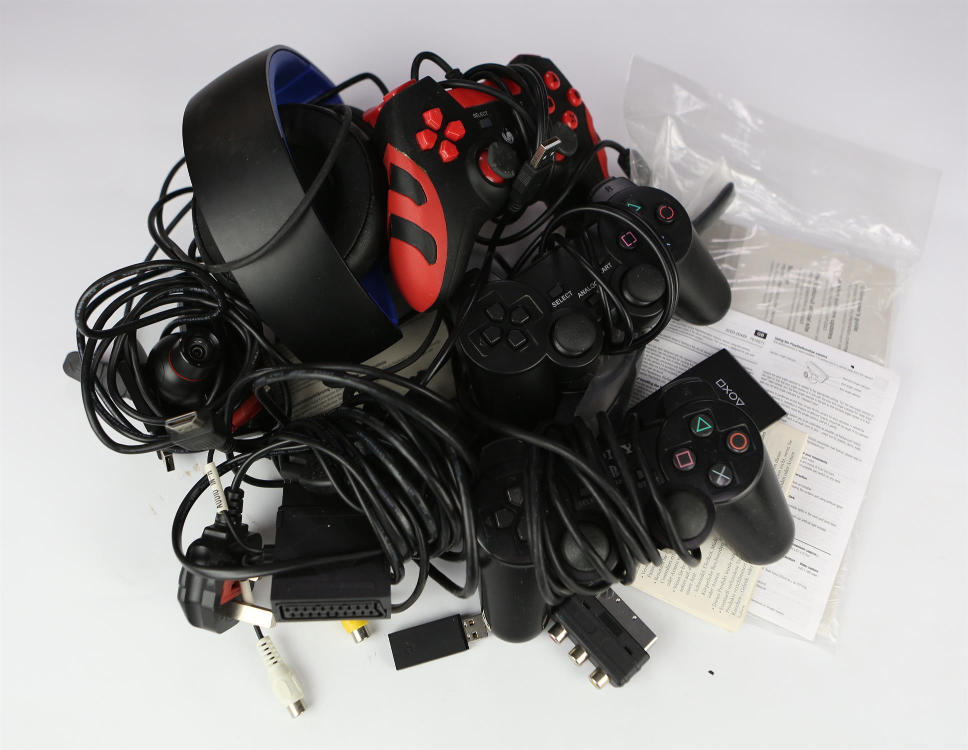 An assortment of controllers, cables and accessories for PlayStation consoles Includes: PS4