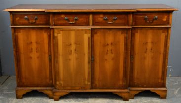 A George III style yew wood breakfront side cabinet, crossbanded, the upper drawers above four