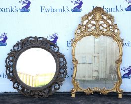 A circular foliate carved wooden framed mirror dia. 80 cm and a smaller gilt framed mirror 64 cm