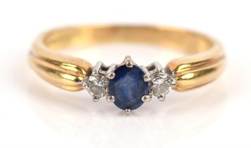 Sapphire and diamond three stone ring, with central oval sapphire flanked either side by a round