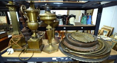 Two brass oil lamp bases, together with a Baroque taste wooden lamp base, a brass urn form base,