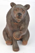 A South German carved bear form tobacco box, 1st quarter 20th century, seated, the head and