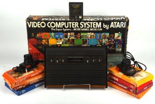 Atari CX-2600 console with driving controllers (x2) and 9 games Games include: Demons to Diamonds,
