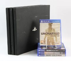 PlayStation 4 Pro (PS4 Pro) black console with 4 games Games include: Uncharted: The Nathan Drake