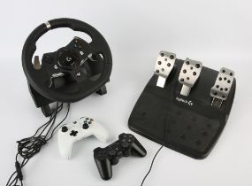 A large assortment of controllers, cables and peripherals for Xbox and PlayStation consoles