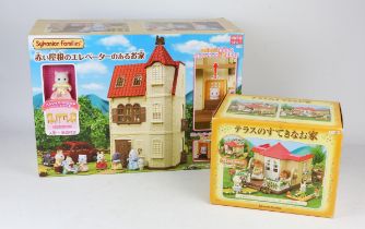 A quantity of Sylvanian Families vintage toys including ; a family house, Village sweet shop,