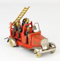 An early 20th century German tinplate clockwork fire engine by George Fischer. Length 11cm.