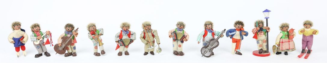 A collection of Austrian 'Peter' hedgehog figures, in various poses , six playing instruments,