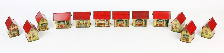 Twelve early 20th century American tinplate confectionary containers, each in the form of a house