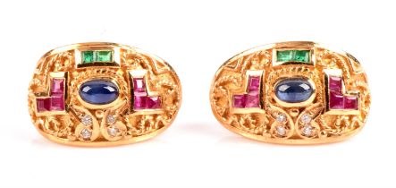 A pair of gem set earrings, with a central cabochon cut sapphire, square calibre cut rubies and