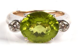 Peridot and diamond ring, with central claw set oval cut peridot weighing an estimated 5.29 carats,