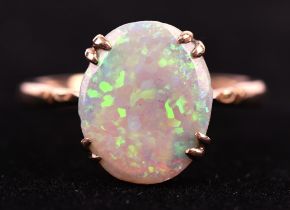 Opal dress ring, oval cabochon cut opal, measuring 13 x 11mm, claw set in 9 ct mount, ring size Q