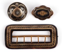 Tortoiseshell pique brooches and a buckle, two brooches, one round and one oval, with base metal