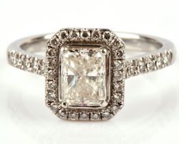 Lunn's diamond ring, central radiant cut diamond 1.30 carats, surrounded by a border of round