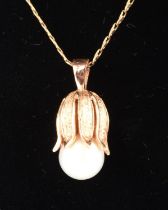 Pearl floral pendant in yellow metal tested as 9 ct gold, on an S link chain in yellow metal tested
