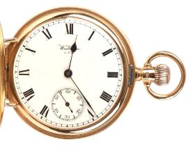 Waltham a Gold hunter pocket watch the case opening to reveal a signed white enamel dial with