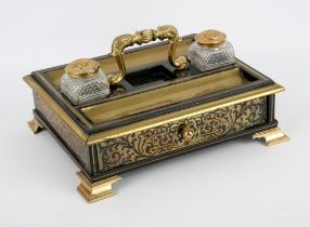 A Regency period ebony and boulle work desk standish, the foliate cast handle flanked by twin glass