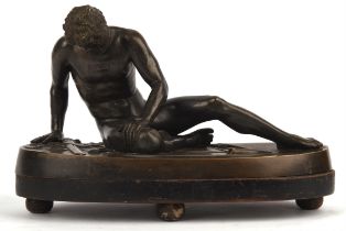 After the Antique. A Bronze of A Dying Gladiator on a bronze base and wooden stand, 30cm x 15cm