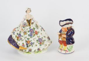 Dresden figure of a lady with a fan, H 25cm and an Allertons Toby jug, H 16cm (2)
