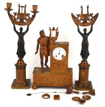 A19th century, French gilt brass mantle clock garniture mounted with a classical figure and a lyre,