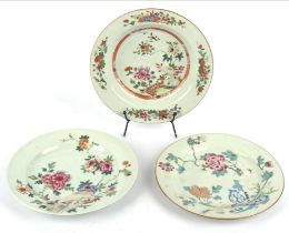 Three famille rose dishes; each one with bold floral designs and about 22cm diameter;all Qianlong