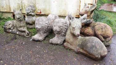 Pair of composition stone seated lions, 55cm long, together with other stone animal figures,