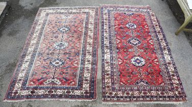 Two similar Persian rugs, 20th century, the central medallions within outer scroll bands, W 124,