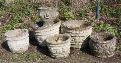 Pair of reconstituted stone planters, moulded in the form of barrels with flower head decoration,
