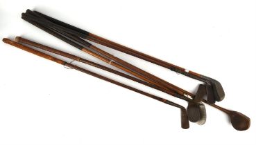 Seven early 20th century golf clubs, each with tapering hickory shafts including ; a Scottish