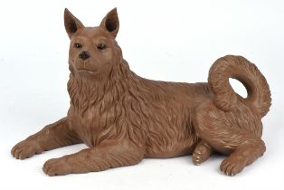 A Chinese redware ceramic model of a recumbent dog, on stand, in a presentation case,