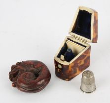 Tortoiseshell and bone thimble case, 19th Century, with sloping lid, containing a thimble, 5cm high,