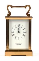 Garrard and Co. Ltd, a brass carriage clock, with white enamel dial, Roman numeral chapter room,