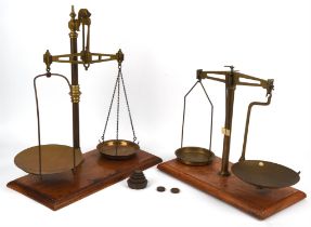 Two pairs of late 19th / early 20th century brass balance scales, the tallest 54cm and one set of