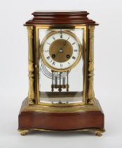An early 20th century French four glass mantel clock of shaped form, the enamelled dial with Roman