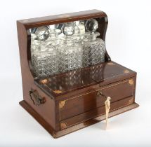 Edwardian tantalus, overall inlay to the case with foliate designs, with three glass decanters,
