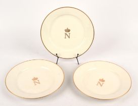 Three Sevres porcelain plates, late 19th Century, gilded to the centres with Napoleon III crests,