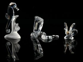 Swarovski, a collection of fourteen glass sculptures, to comprise a cobra, a seated deer,