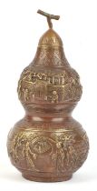 A Chinese, or other Asian, metal vase and domed cover of double gourd form; decorated with a number