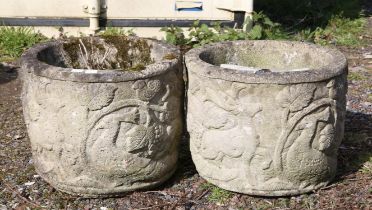 Pair of reconstituted stone planters, moulded with deer and birds, within foliage,