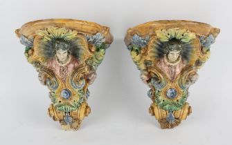 A pair of Italian majolica wall brackets, each with a Renaissance male figure within a shell and